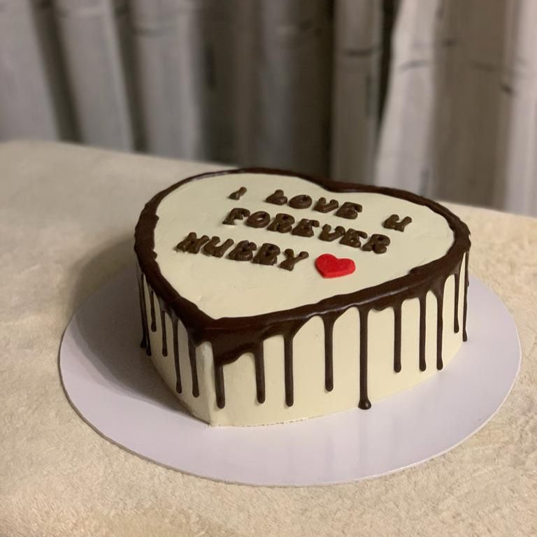Heart-shaped cake with chocolate drizzle