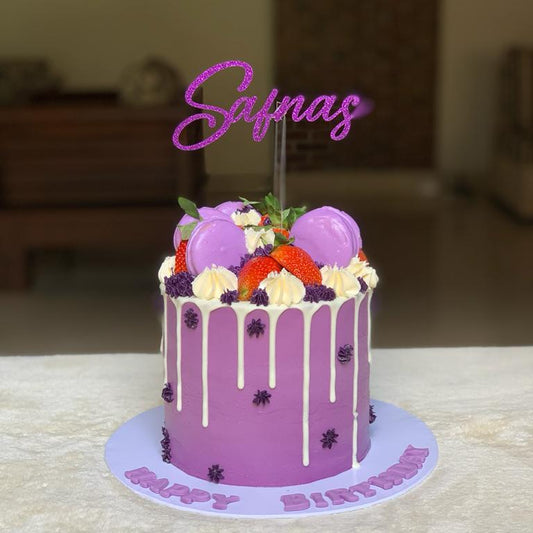Purple birthday cake with floral decorations